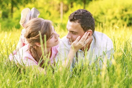 Close-up of a young couple in love on grass