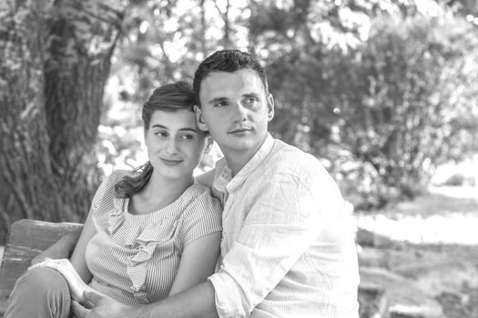 Young couple relaxing in park on a bench