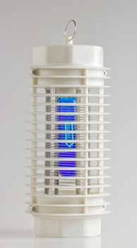 Entire view of a white mosquito lamp with blue light