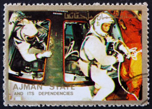 AJMAN - CIRCA 1973: a stamp printed in the Ajman shows Astronauts and Command Module, Space Exploration Program, Apollo, circa 1973