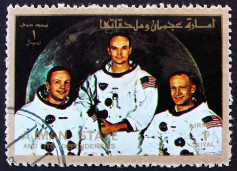 AJMAN - CIRCA 1973: a stamp printed in the Ajman shows Crew of Apollo 11, Neil Armstrong, Buzz Aldrin and Michael Collins, Moon-landing, Apollo 11, circa 1973