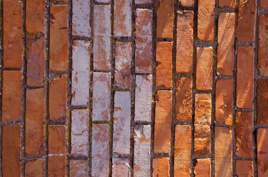 Wall made of red and colored bricks. Architectural decision.