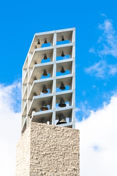 Two bells on the tower against the blue sky