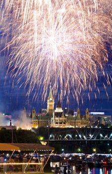 The canadian Parliament in all its glory surrounded by fireworks on Canada Day.