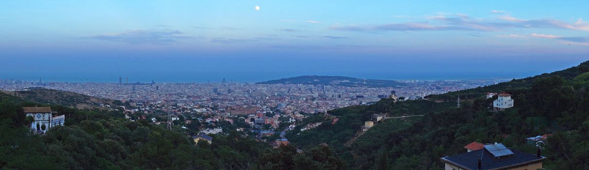 Panoramic view of Barcelona City, Spain at moonrise time.