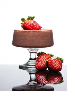 Chocolate mousse dessert with delicious red strawberries. Isolated on white