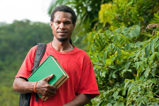 Young south east asian male student carrying books and backpack