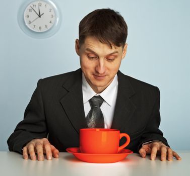 Businessman going to drink a very strong and very hot coffee