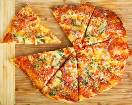 A delicious homemade pizza on a wooden chopping board.