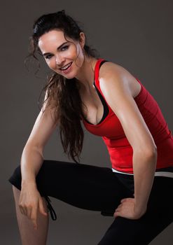 A happy beautiful young sexy woman having a rest after exercise