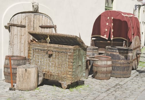 Old-fasioned wooden stuff: barrels, chest, carriage