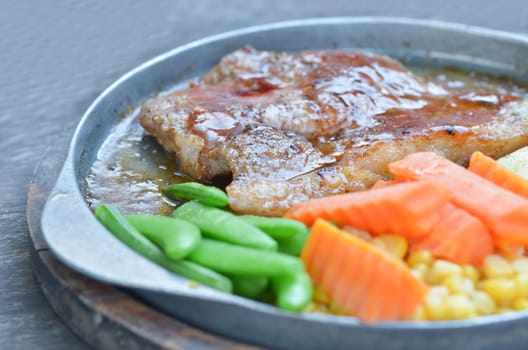 pork steak with tomato sauce served with vegetable