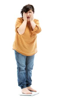 Terrified women with overweight standing on a scale  - cutout on white