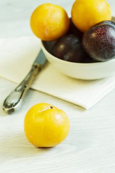 Different varieties of plums on the table
