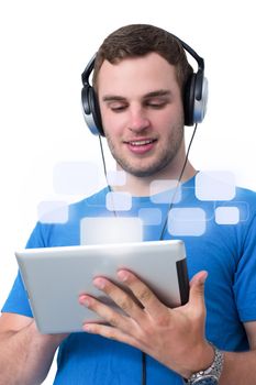 Young man with headphones and blue t-shirt working on a tablet pc