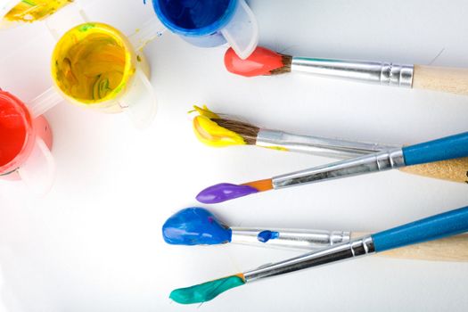 Stock photo: an image of five paintbrushes and three paints