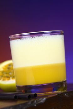 Maracuya Sour, a popular Peruvian cocktail made of maracuya and lime juice, pisco, syrup and egg white (Selective Focus, Focus on the front of the glass)