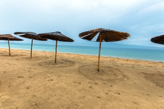 Tropical scene with Parasol and beach beds