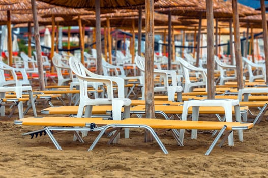 Tropical scene with Parasol and beach beds