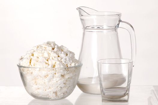 White still-life with milk and cottage cheese on white background