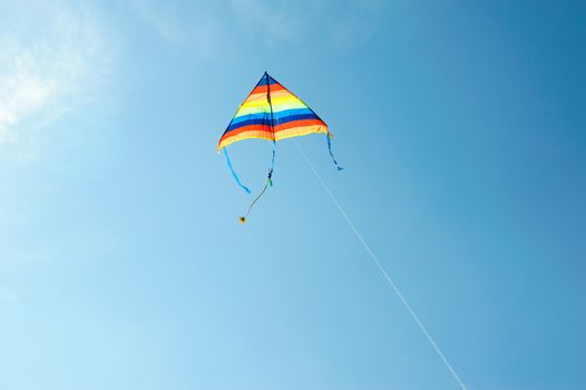 An image of a bright kite in the blue sky