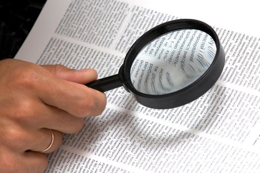 An image of magnifier in hand