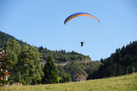 An image of a man flying on a parachute