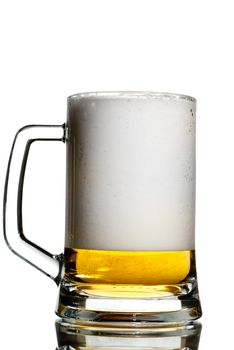 Massive beer foam buildup in a glass isolated on white