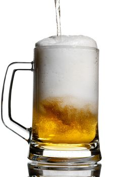 Pouring a light beer in a transparent keg isolated on white