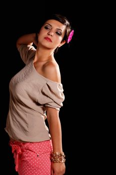 Dark haired girl with a gray shirt isolated on black