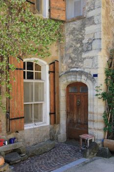 House in typical provencal style in France, windows with wooden shutters