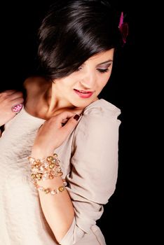 Side profile of a brunette in a dress isolated on black