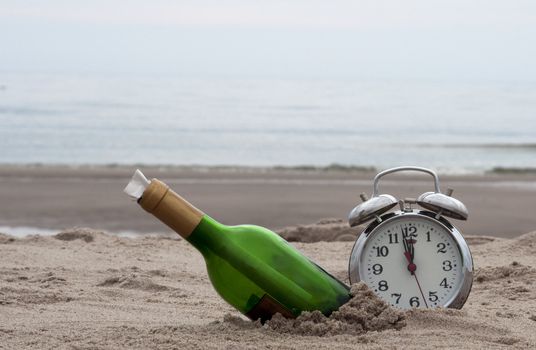 green bottle post and a clokc on the beach