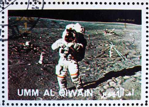UMM AL-QUWAIN - CIRCA 1972: a stamp printed in the Umm al-Quwain shows Astronaut walks on the Surface of the Moon, Moon-landing, Apollo, circa 1972