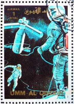 UMM AL-QUWAIN - CIRCA 1972: a stamp printed in the Umm al-Quwain shows Astronauts and Space Station, Artist�s Vision, Space Exploration, circa 1972