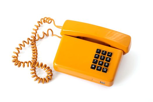 Old orange telephone isolated on white background
