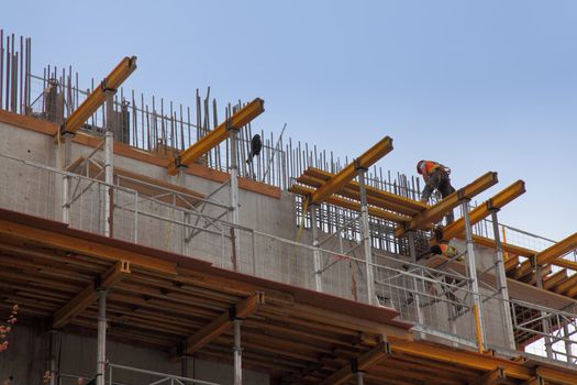 workers in action during construction of a steel beam office building