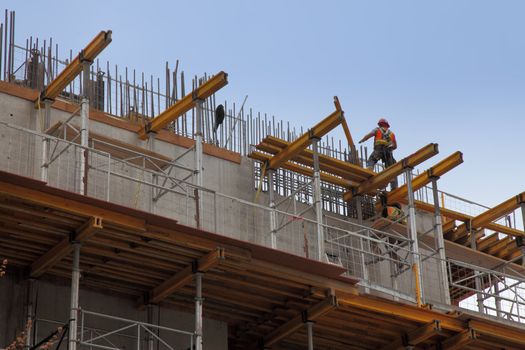 workers in action during construction of a steel beam office building