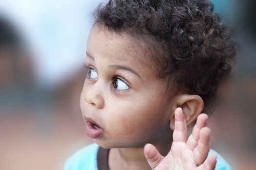 little multiracial boy gesturing to say no