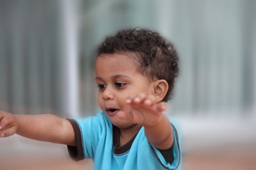 cute little multiracial boy playing pretending to fly