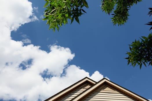 house roof peak against blue sky