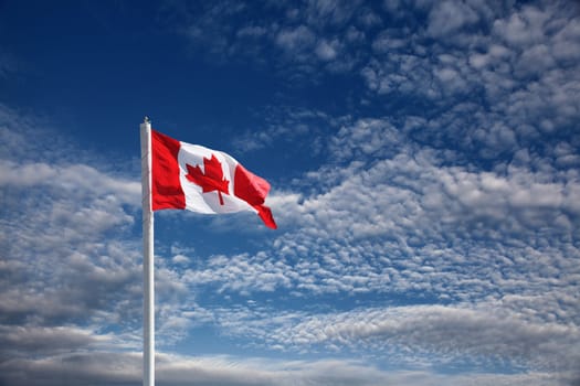 canadian flag against blue sky