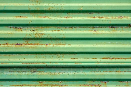 Old rusty metal ribbed surface painted in green color