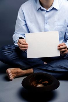 An image of a beggar with a hat and a blank sheet of paper