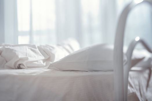 Bedroom with bed and linen. Natural light