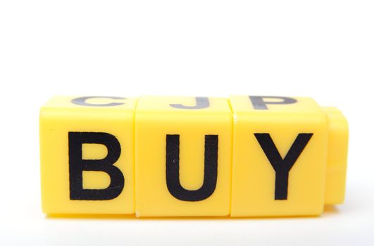 An image of yellow bricks with word ''buy'' on them