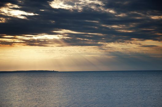 Horizontal photo of the ocean during beautiful dark sunset