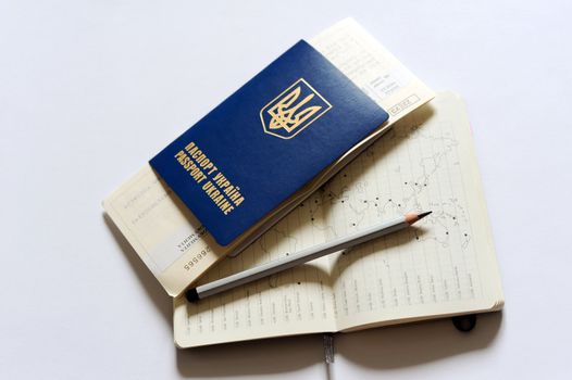 An image of a passport, tickets and a map