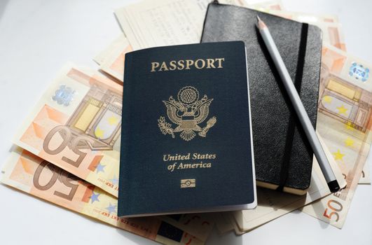 An image of a passport and money on the table