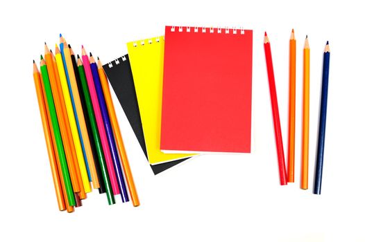 An image of notebooks with pencils on white background